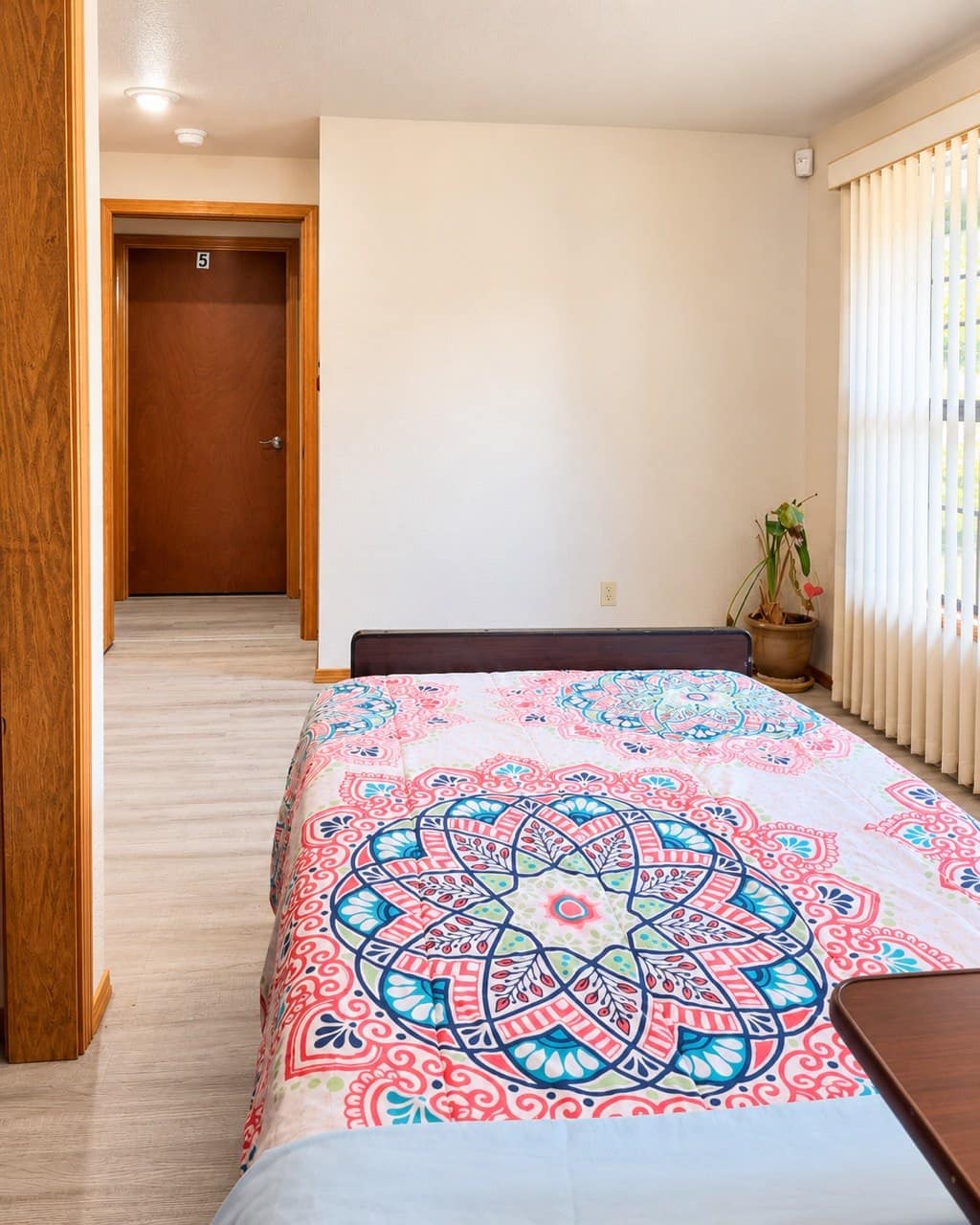 Sunlit resident bedroom with large windows at HopeSprings adult family home